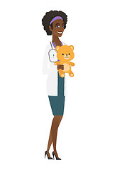 Image showing Pediatrician doctor holding teddy bear.