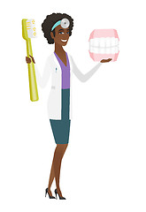 Image showing Dentist with dental jaw model and toothbrush.