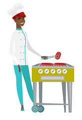 Image showing Chef cook cooking steak on barbecue grill.