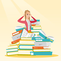 Image showing Student sitting in huge pile of books.