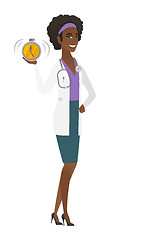 Image showing African-american doctor holding alarm clock.