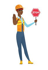 Image showing African-american builder holding stop road sign.