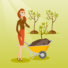 Image showing Woman pushing wheelbarrow with plant.