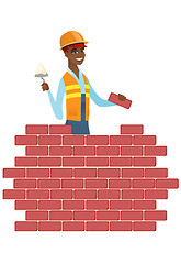 Image showing Bricklayer working with spatula and brick.
