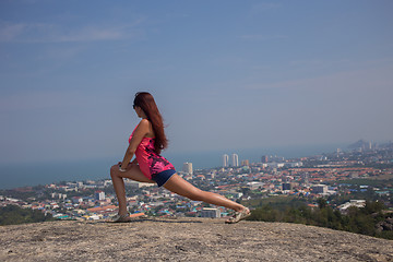 Image showing Young brunette doing stretching exercises