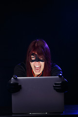 Image showing Screaming girl hacker at night