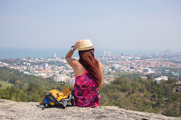 Image showing Girl sits on hill