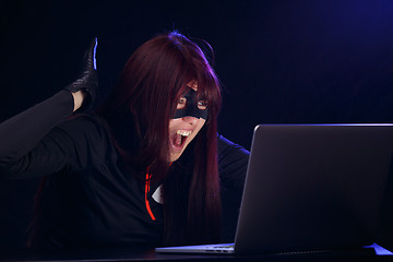 Image showing Girl thief in black mask