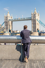 Image showing British businessman talking on mobile phone outdoor in London city, UK.