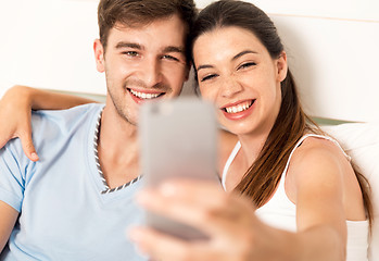 Image showing Couple on bed making selfies