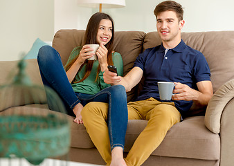 Image showing Watching tv and drinking coffee