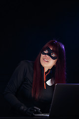 Image showing Hacker in mask with laptop