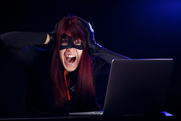 Image showing Girl hacker in black mask