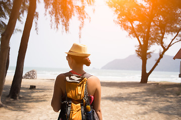 Image showing Woman in hat stands back