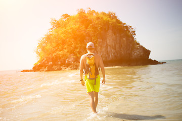 Image showing Young guy walks by seashore