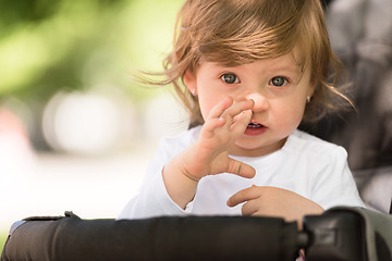 Image showing baby girl sitting in the pram