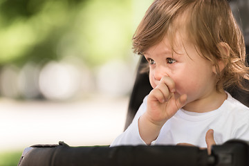 Image showing baby girl sitting in the pram