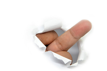 Image showing Middle finger through the paper hole