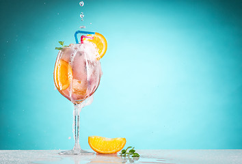 Image showing The rose exotic cocktail and fruit on blue