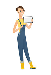 Image showing Smiling farmer holding tablet computer.