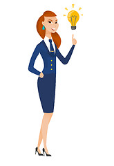 Image showing Stewardess pointing at bright idea light bulb.