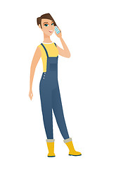 Image showing Farmer talking on a mobile phone.