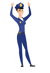 Image showing Policewoman standing with raised arms up.