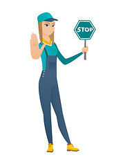 Image showing Caucasian mechanic holding stop road sign.