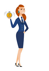 Image showing Caucasian stewardess holding alarm clock.