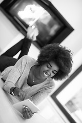 Image showing black women used tablet computer on the floor