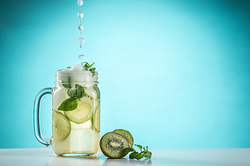 Image showing The rose exotic cocktail and fruit on blue