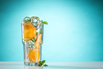 Image showing The rose exotic cocktail and fruit on blue