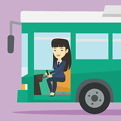 Image showing Asian bus driver sitting at steering wheel.