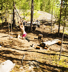 Image showing little cute boy jumping with bungee in forest, training with dad