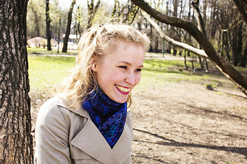 Image showing young pretty blonde girl engoing spring nature in park, lifestyle epople concept