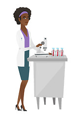 Image showing Laboratory assistant working with microscope.