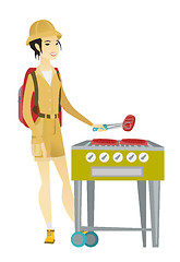 Image showing Traveler woman cooking steak on barbecue grill.