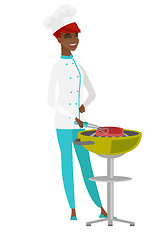 Image showing Chef cook cooking steak on barbecue grill.