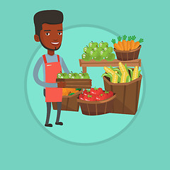 Image showing Supermarket worker with box full of apples.