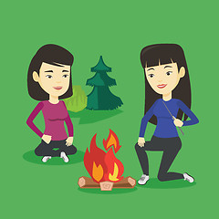 Image showing Two friends sitting around bonfire in camping.