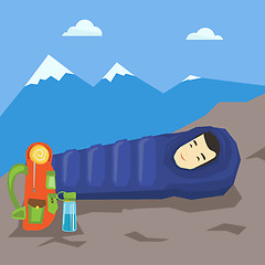 Image showing Man sleeping in sleeping bag in the mountains.