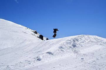 Image showing Snowboarder jumping in snow park at ski resort on sun winter day