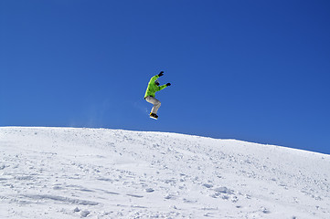 Image showing Snowboarder jump in snow park at ski resort on sun day