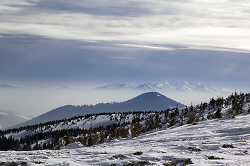 Image showing Winter mountains and sunlight cloudy sky in haze