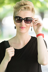 Image showing young woman with short blond hair and sunglasses