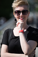 Image showing young woman with short blond hair and sunglasses