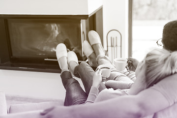 Image showing Young multiethnic couple  in front of fireplace