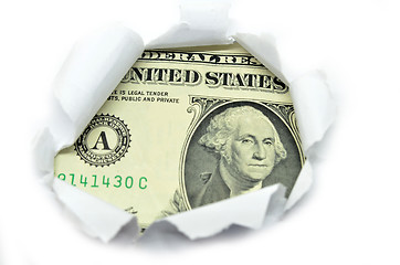 Image showing US currency peeking through white paper.