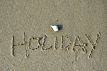 Image showing Word holiday written in the sand 