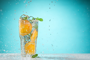 Image showing The rose exotic cocktail and fruit on blue